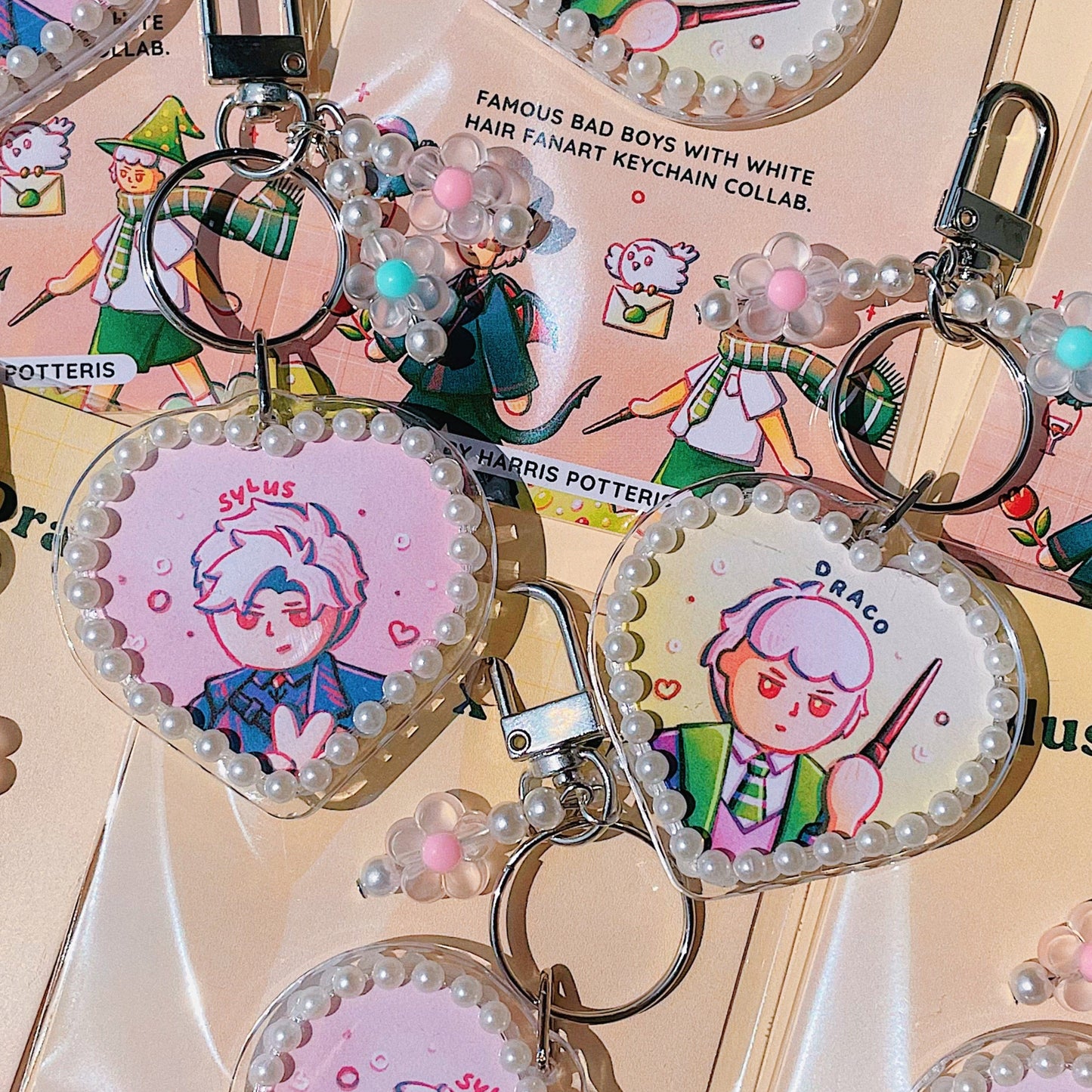 Keychains with cartoon character designs on a pink background